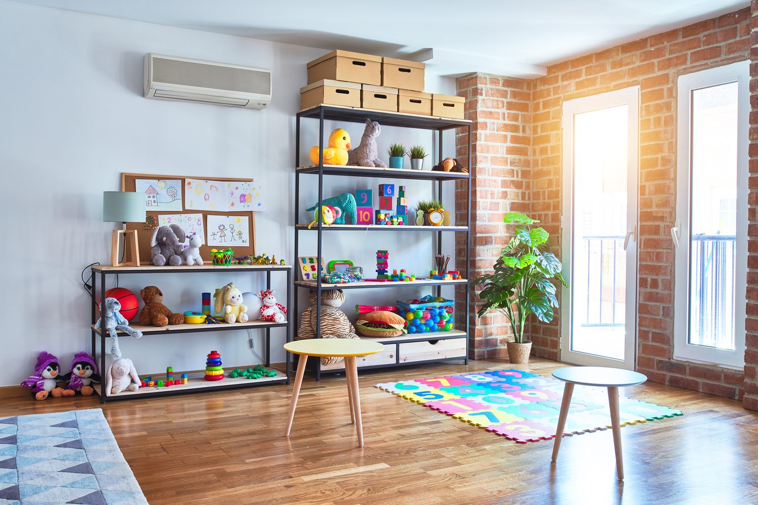 Clean children’s nursery playroom Bright, tidy nursery playroom with toy shelves and play mat
